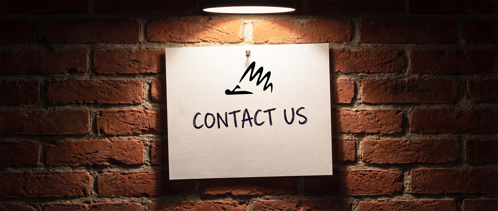 Contact us sign on a brick wall